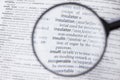 Dictionary page viewed through magnifying glass
