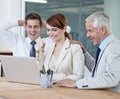 We did ti. surprised colleagues looking at a laptop in a boardroom. Royalty Free Stock Photo