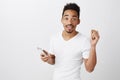 Did you ask something. Portrait of interrupted carefree young guy with beard, holding smartphone, standing in subway Royalty Free Stock Photo