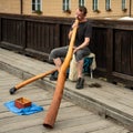 Didjeridoo Player on the bridge to old town Cesky Kromlov, Czech Republic Royalty Free Stock Photo