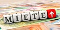 Dices with the German word `Miete` rent on many Euro banknotes Royalty Free Stock Photo