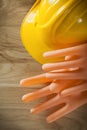 Dielectric gloves safety cap on wooden board Royalty Free Stock Photo