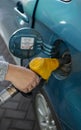 Hand refueling the fuel tank of the machine with diesel or gasoline at a filling station Royalty Free Stock Photo