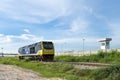 Diesel engine train head run on railway track with cloudy and blue sky