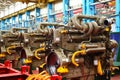 Diesel engines with huge turbines on assembly line in the workshop of the factory for the production of large mining trucks.