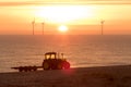 Diesel fossil fuel tractor highlighted by solar and wind energy