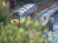 A diesel locomotive on the South Devon railway near Dawlish with red cliffs behind