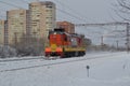 Diesel powered locomotive in the snow. Winter day on the railway in Russia