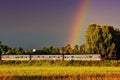 Diesel railcar passes the rainbow Royalty Free Stock Photo