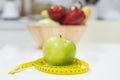 Diet breakfast concept. green apple and measure tape Royalty Free Stock Photo