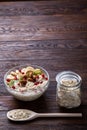 Diet breakfast oatmeal with fruits, bowl and spoon with oat flakes, selective focus, close-up Royalty Free Stock Photo