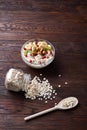 Diet breakfast oatmeal with fruits, bowl and spoon with oat flakes, selective focus, close-up Royalty Free Stock Photo