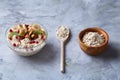 Diet breakfast oatmeal with fruits, bowl and spoon with oat flakes, selective focus, close-up Royalty Free Stock Photo