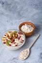 Diet breakfast oatmeal with fruits, bowl and spoon with oat flakes, selective focus, close-up Royalty Free Stock Photo