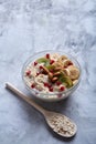 Diet breakfast oatmeal with fruits, bowl and spoon with oat flakes, selective focus, close-up Royalty Free Stock Photo