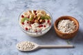Diet breakfast oatmeal with fruits, bowl and spoon with oat flakes, selective focus, close-up Royalty Free Stock Photo