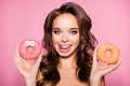 Diet, calories, healthcare, willpower, summer, body care, concept. Close up portrait of happy girl looking camera with donutes in