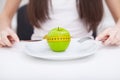 Diet. Close up photo of tape measure coiled around an apple on w Royalty Free Stock Photo