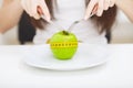 Diet. Close up photo of tape measure coiled around an apple on w Royalty Free Stock Photo