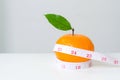 Diet concep, Orange fruit and measuring tape Royalty Free Stock Photo