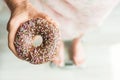 Diet Concept. Close-up of Woman`s feet On Weighing Scale With Donut. Concept of Sweets, Unhealthy Junk Food and obesity. Royalty Free Stock Photo