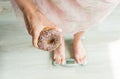 Diet Concept. Close-up of Woman`s feet On Weighing Scale With Donut. Concept of Sweets, Unhealthy Junk Food and obesity. Royalty Free Stock Photo