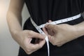 Diet concept close up women measuring waist circumference.
