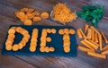 Diet concept. Different cuts of carrots on a wooden table, word diet on black cutting board Royalty Free Stock Photo