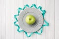 Diet concept. Green Apple on a plate and tape centimeter on a white table Royalty Free Stock Photo