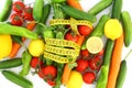 diet concept with measuring tape . fresh vegetables on a white background. Royalty Free Stock Photo