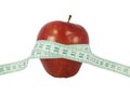 Diet concept with a red apple and a measure tape Royalty Free Stock Photo