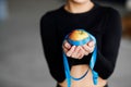 Diet concept. A red apple wrapped in a blue measuring tape, a girl holds an apple in her hands Royalty Free Stock Photo