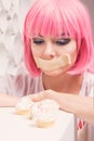 The diet concept. sad girl with taped mouth looking to sweets Royalty Free Stock Photo