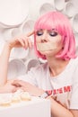 Diet concept. sad girl with taped mouth looking to sweets Royalty Free Stock Photo