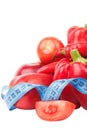 Diet concept: Set from red bell pepper, red hot chili pepper and apple with measuring tape Royalty Free Stock Photo