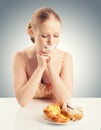 Diet concept. woman mouth sealed with duct tape with buns Royalty Free Stock Photo