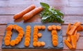 Diet concept. Wooden table with whole and sliced carrots Royalty Free Stock Photo