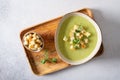 Diet detox food concept. Healthy broccoli green pea cream soup in bowl over light stone background. Top view, close up. Spring Royalty Free Stock Photo