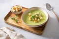 Diet detox food concept. Healthy broccoli green pea cream soup in bowl over light stone background. Side view, close up. Spring Royalty Free Stock Photo