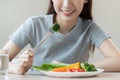Diet, Dieting asian young woman or girl use fork at broccoli on mix vegetables, green salad bowl, eat food is low fat good health Royalty Free Stock Photo