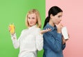 Diet. Dieting concept. Healthy Food. Beautiful Young Women choosing between fruit orange juice and unhelathy carbonated Royalty Free Stock Photo