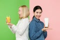 Diet. Dieting concept. Healthy Food. Beautiful Young Women choosing between fruit orange juice and unhelathy carbonated Royalty Free Stock Photo