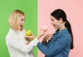 Diet. Dieting concept. Healthy Food. Beautiful Young Women choosing between fruits and unhelathy cake Royalty Free Stock Photo