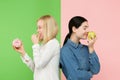 Diet. Dieting concept. Healthy Food. Beautiful Young Women choosing between fruits and unhelathy cake Royalty Free Stock Photo