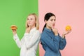 Diet. Dieting concept. Healthy Food. Beautiful Young Women choosing between fruits and unhelathy fast food Royalty Free Stock Photo