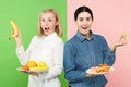 Diet. Dieting concept. Healthy Food. Beautiful Young Women choosing between fruits and unhelathy fast food Royalty Free Stock Photo