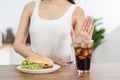 Diet, Dieting hand of asian young woman deny, avoid hamburger, junk or fast food and sparkling water, soft drink, eat food for Royalty Free Stock Photo