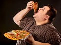 Fat man eating fast food slice pizza . Breakfast for overweight person. Royalty Free Stock Photo