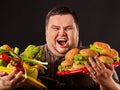 Diet fat man makes choice between healthy and unhealthy food. Royalty Free Stock Photo