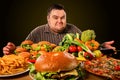 Diet fat man makes choice between healthy and unhealthy food. Royalty Free Stock Photo